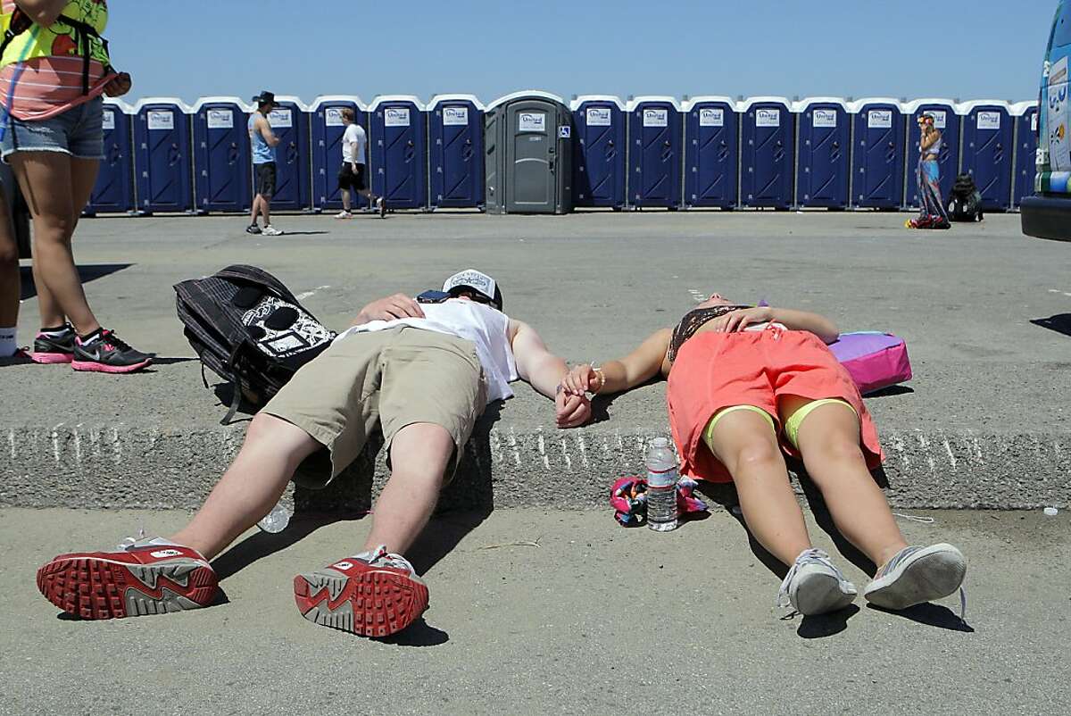 Two people resting not far from the finishing line during the 101st Bay to Breakers foot race in San Francisco, Calif. on May 20, 2012.