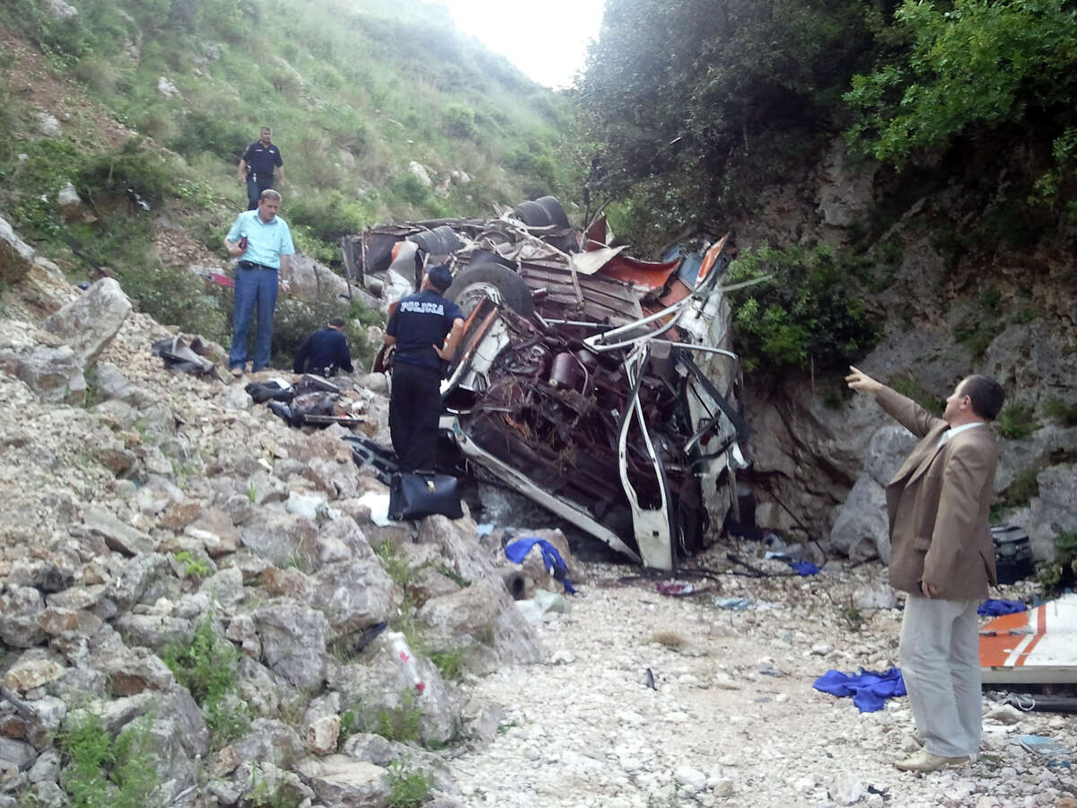 Rescue personnel attend the scene of a bus accident as the bus lies at the bottom of a cliff near Himare southern Albania on Monday, May 21, 2012. The accident killed a number of people and injured tens of others authorities said. Local prefect Edmond Velcani said the bus driver was among the people killed. The bus had been heading from the city of Elbasan to the southern city of Saranda. Police spokeswoman Klejda Plangarica said the bus fell some 80 meters (yards) off the road in Qafa e Vishes near the town of Himare, 137 miles (220 kilometers) south of the capital, Tirana, on Monday afternoon. (AP Photo)