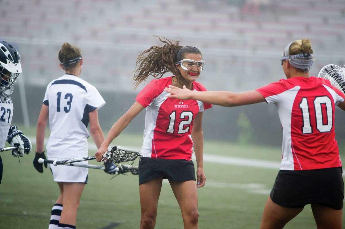 Greenwich's Caroline Brennan celebrates scoring with teammate Emily Johnson, right, as Greenwich and Wilton face off in the FCIAC Girls Lacrosse Semifinals at Dunning Field in New Canaan, Conn., May 21, 2012.