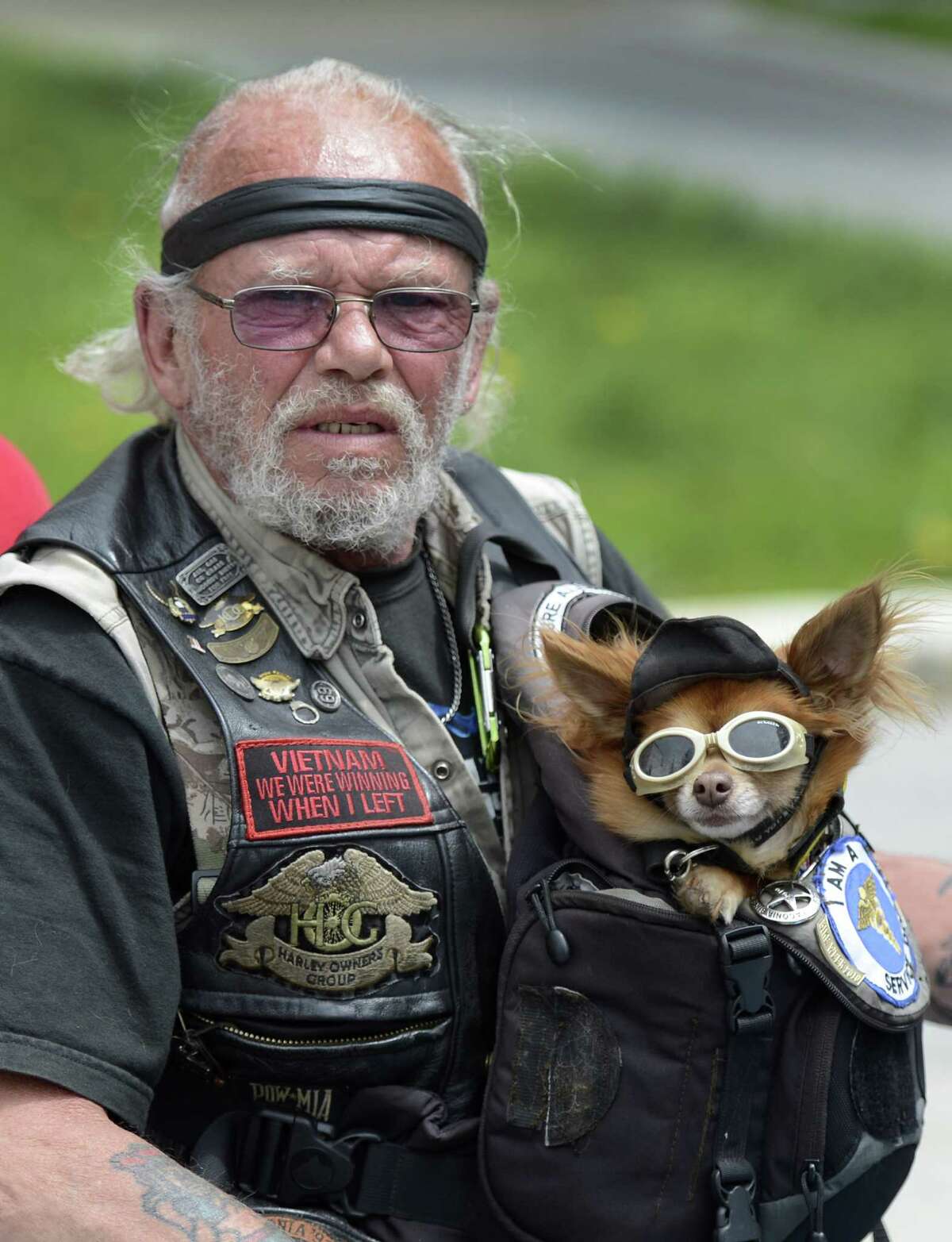 Robert Shoemaker holds his dog Oso and joined approximately 250 anti-helmet law demonstrators who descended on the state capitol in Albany, N.Y., May 21, 2012. (Skip Dickstein / Times Union)