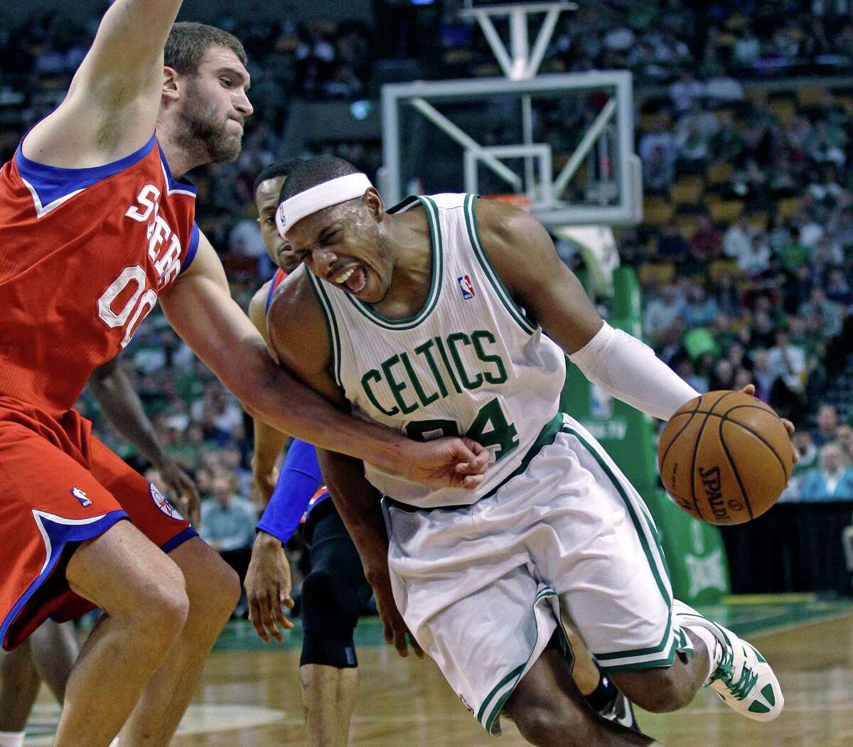 Boston Celtics' Paul Pierce, right, tries to drive past Philadelphia 76ers defender Spencer Hawes, left, during the first quarter of Game 5 in their NBA basketball Eastern Conference semifinal playoff series in Boston, Monday, May 21, 2012. The Celtics won 101-85 to take a 3-2 series lead. (AP Photo/Charles Krupa)