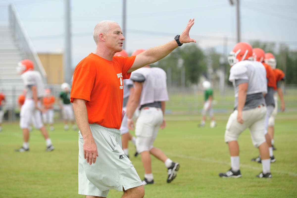 Orangefield's new head football coach Brian Huckabay works with his players during a team practice on Tuesday. August 18, 2009. Valentino Mauricio/The Enterprise