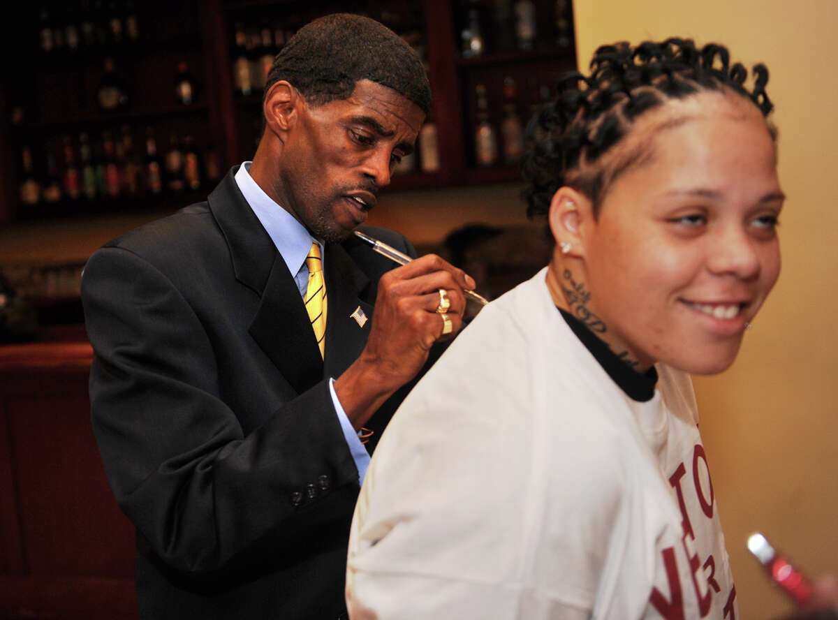 Ernest Newton signs the t-shirt of supporter Janesha Rodriguez after winning the Democratic party nomination for state Senate at Testo's restaurant in Bridgeport, Conn. on Monday, May 21, 2012.