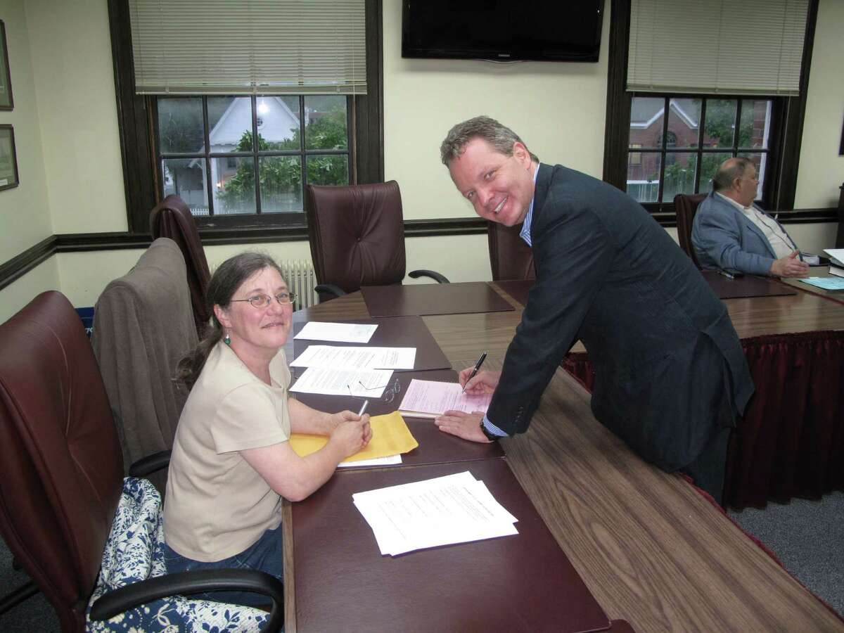 Selectman Beth Jones with new Democratic candidate for the 125th District, Mark Robbins, as he signs the party's official endorsement papers Tuesday night at New Canaan Town Hall. May 21, 2012. New Canaan, CT