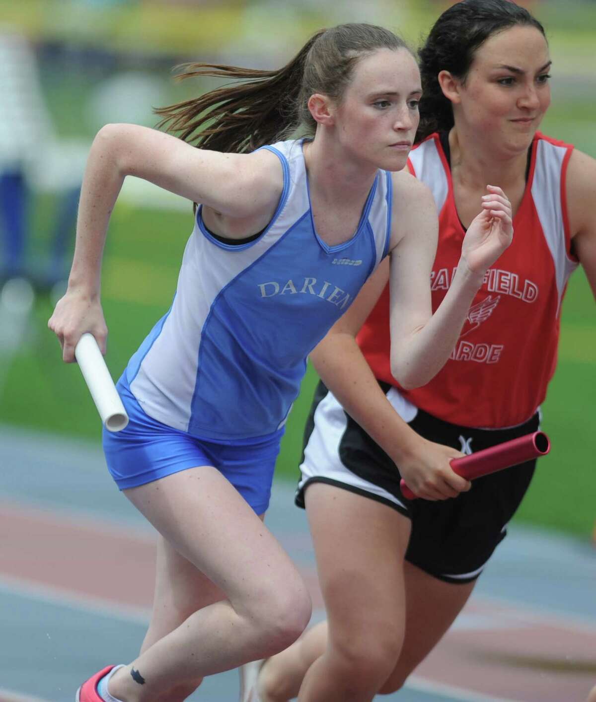 Darien's Sarah Colon, far left, competes in the 4x800 meter relay during the FCIAC boys and girls track championships held Tuesday, May 22, 2012 at Danbury High School.