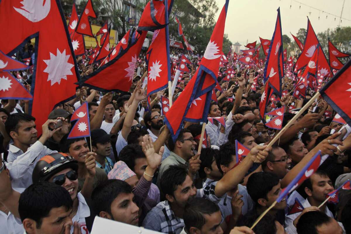 Nepalese people wave the national flag as they attend a rally demanding peace, social harmony and drafting the constitution on time in Katmandu, Nepal, Wednesday, May 23, 2012. Nepal's government wants the repeatedly extended Constituent Assembly to get yet another three months to finish writing the Himalayan nation's constitution, and even members of the ruling parties are crying foul. (AP Photo/Binod Joshi)