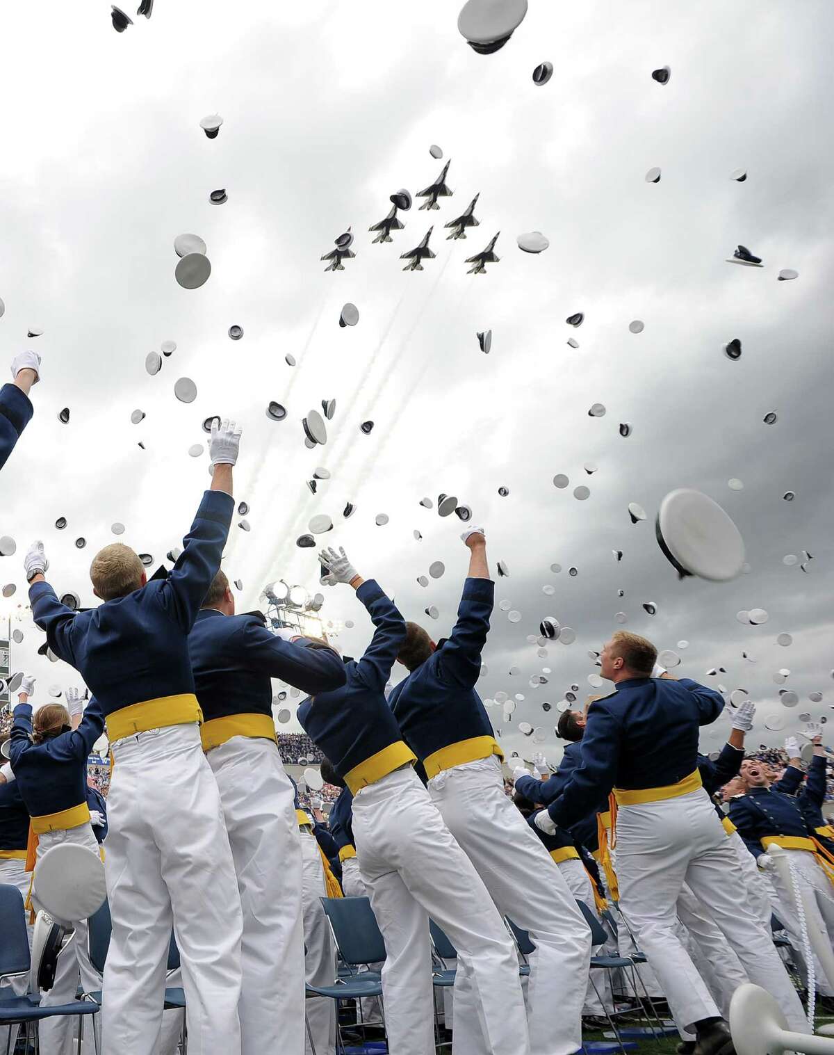 Graduates of US Air Force class 2012 throw their hats in the air as fighter jets fly past during their graduation ceremony at the US Air Force Academy in Colorado Springs, Colorado, on May 23, 2012. AFP PHOTO/Jewel SamadJEWEL SAMAD/AFP/GettyImages