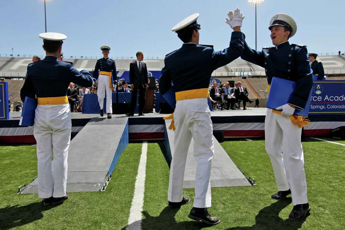 Cadets celebrate after being congratulated by President Barack Obama, center, during the graduation ceremonies at the U.S. Air Force Academy, Wednesday, May 23, 2012, in Colorado Springs, Colo. (AP Photo/Pablo Martinez Monsivais)