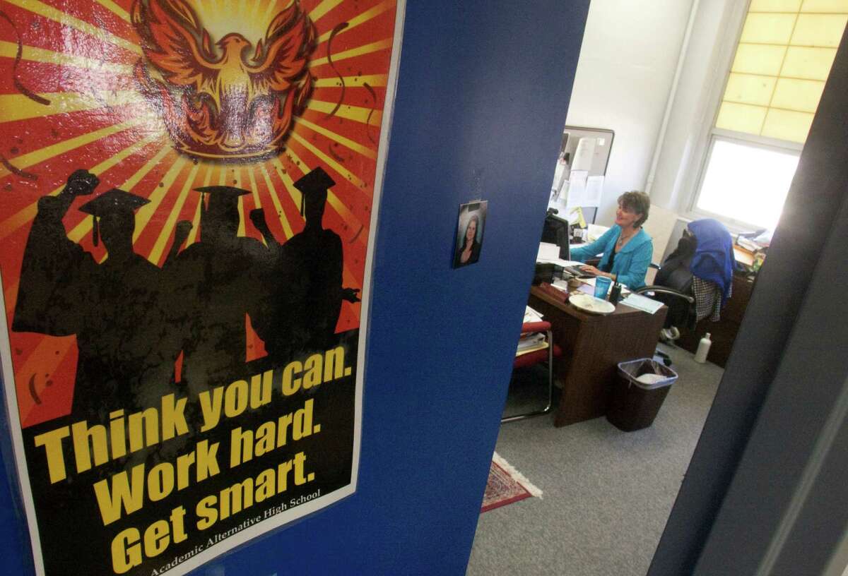 Hauke Alternative High School principle Jo Ann Beken has a poster of the school mascot, the phoenix, on her office door. The phoenix is a mythological firebird that is reborn and rises from its own ashes.