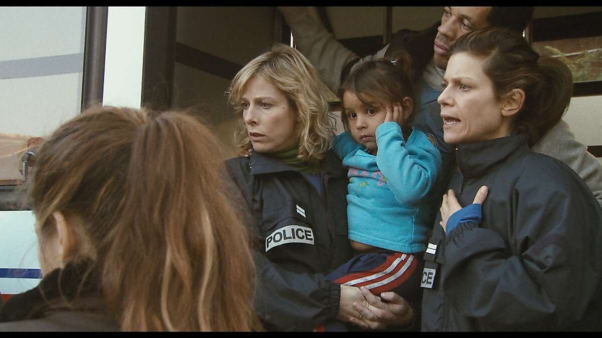 ?’Nadine carrying a Romanian child?“ with Karin Viard as ?’Nadine?“ and Marina Fois as ?’Iris?“ in POLISSE, directed by Ma•wenn.