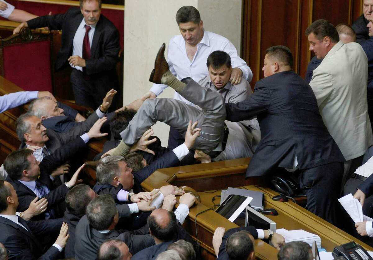 Lawmakers from pro-presidential and oppositional factions fight in the parliament session hall in Kiev, Ukraine, Thursday, May 24, 2012. A violent scuffle erupted in Ukraine's parliament over a bill that would allow the use of the Russian language in courts, hospitals and other institutions in the Russian-speaking regions of the country.