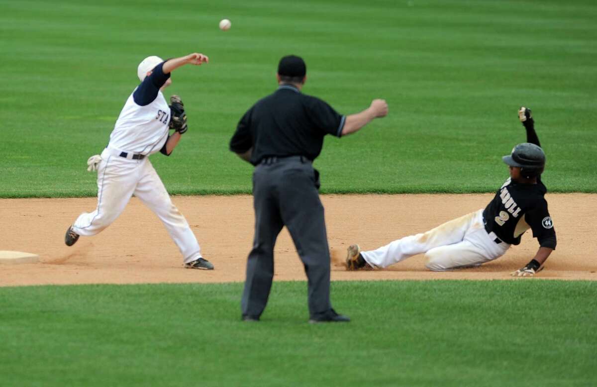 Staple's Benjamin Greenberg attempts a double play as Trumbull's Marcus Jenkins slides to second during the FCIAC baseball semifinals Thursday, May 24, 2012 at the Ballpark at Harbor Yard in Bridgeport, Conn.