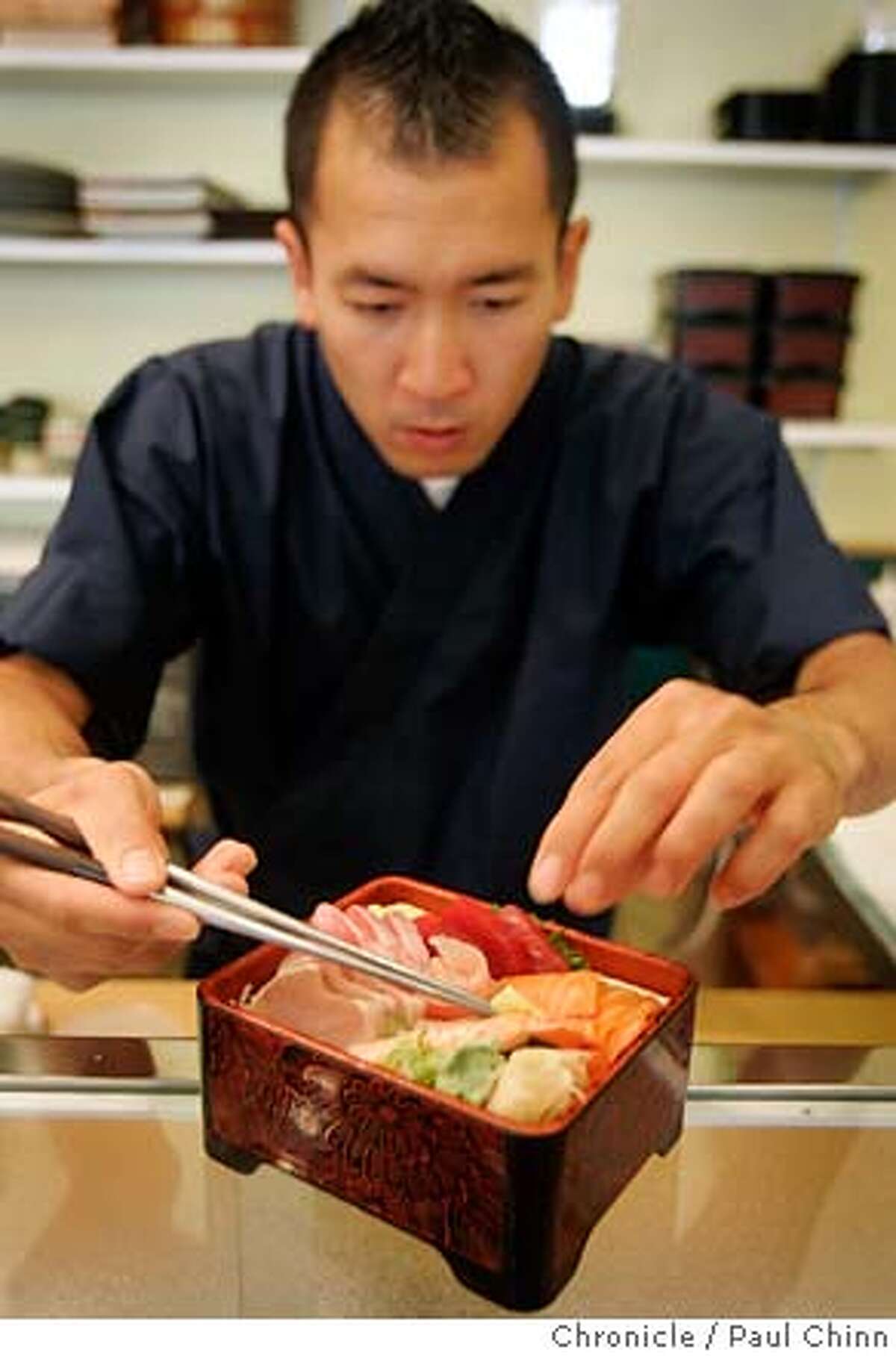 Chef Sean Buyan adds the finishing touches to an order of chirashi sushi at Musashi Japanese restaurant in Berkeley, Calif. on Tuesday, June 19, 2007. PAUL CHINN/The Chronicle **Sean Buyan MANDATORY CREDIT FOR PHOTOGRAPHER AND S.F. CHRONICLE/NO SALES - MAGS OUT