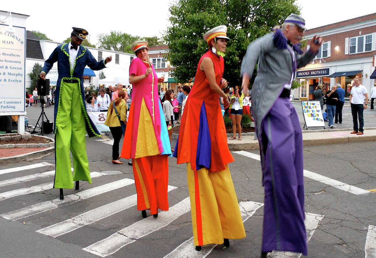 Performers on stilts from the troupe the Mortal Beasts & Deities step along a crosswalk, mimicking the Beatles' famous Abbey Road crossing, at Art About Town in downtown Westport on Thursday.