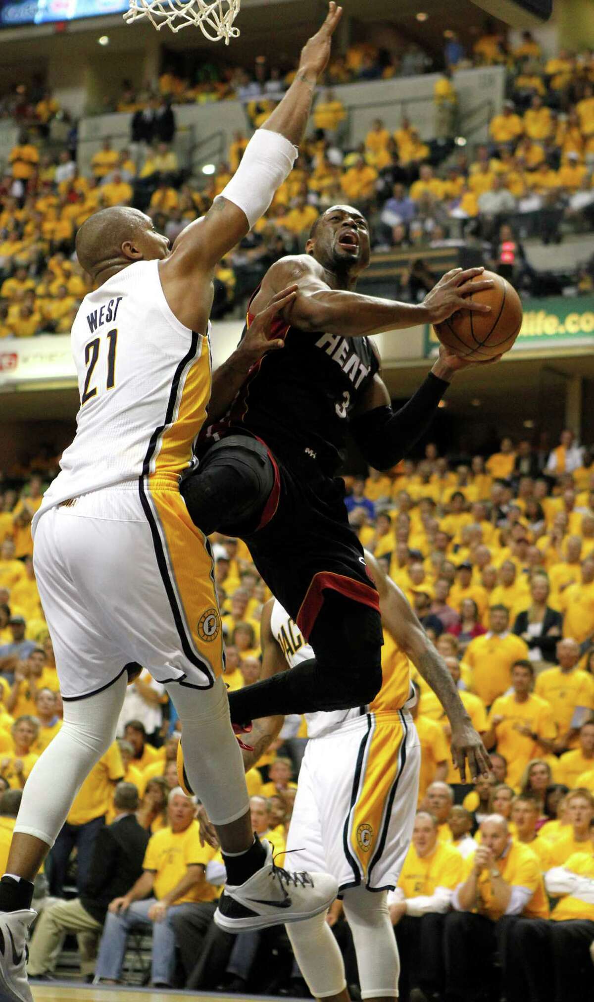 Miami Heat's Dwyane Wade is fouled by Indiana Pacers' David West late in the fourth quarter in the Eastern Conference Semifinals in Round 2, Game 6 at the Bankers Life Field House in Indianapolis, Indiana on May 24, 2012 The Heat won 105-93 to win the series 4-2. (AP Photo/Charles Trainor, Miami Herald)
