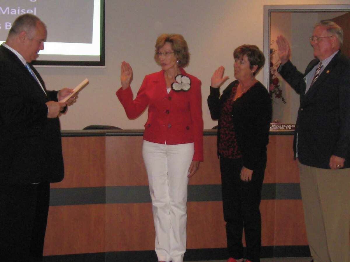 Shavano Park Mayor David Marne reads the oath of office to elected City Council members Etta Fanning, Vicky Maisel and Charlie Brame.