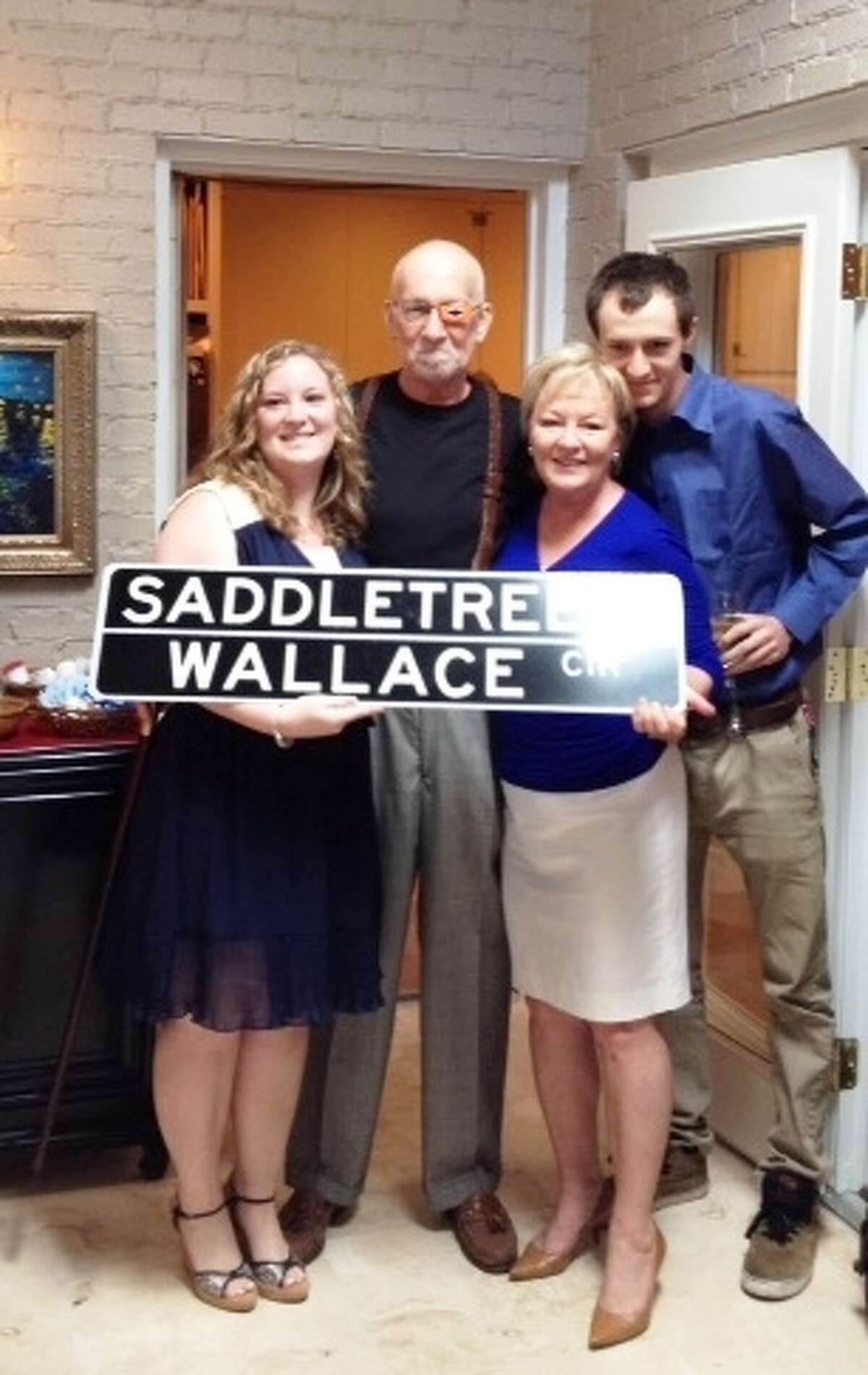 Longtime Shavano Park resident Don Wallace poses with daughter Whitney, wife Susan, and son Keaton upon seeing the street sign rededicated in his honor.