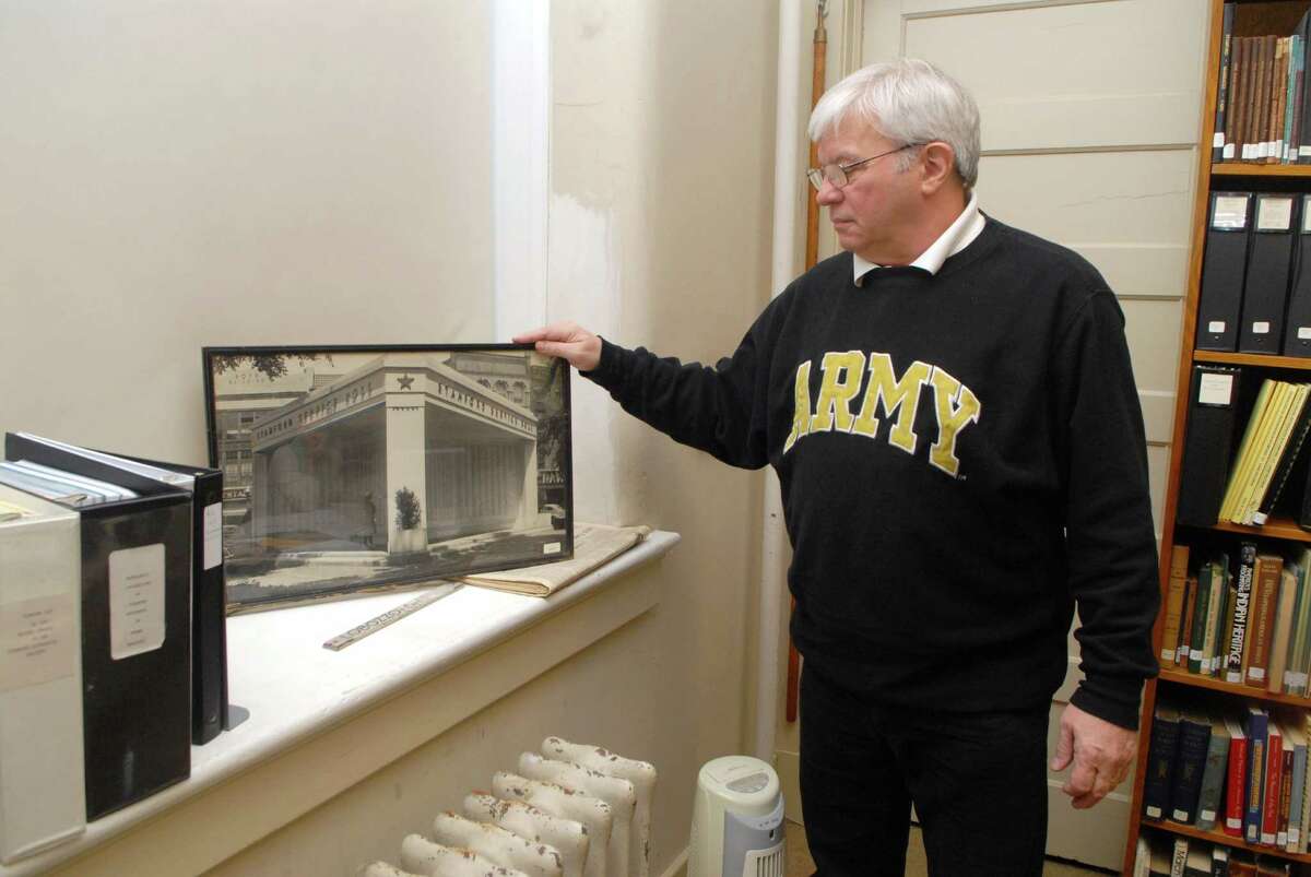 Dan Burke on Friday April 27, 2012 at the Stamford Historical Society in Stamford, Conn. where he's worked researching trying to piece together the names of all WWII veterans from Stamford. He holds a photo of a memorial that was in Veteran's Park.