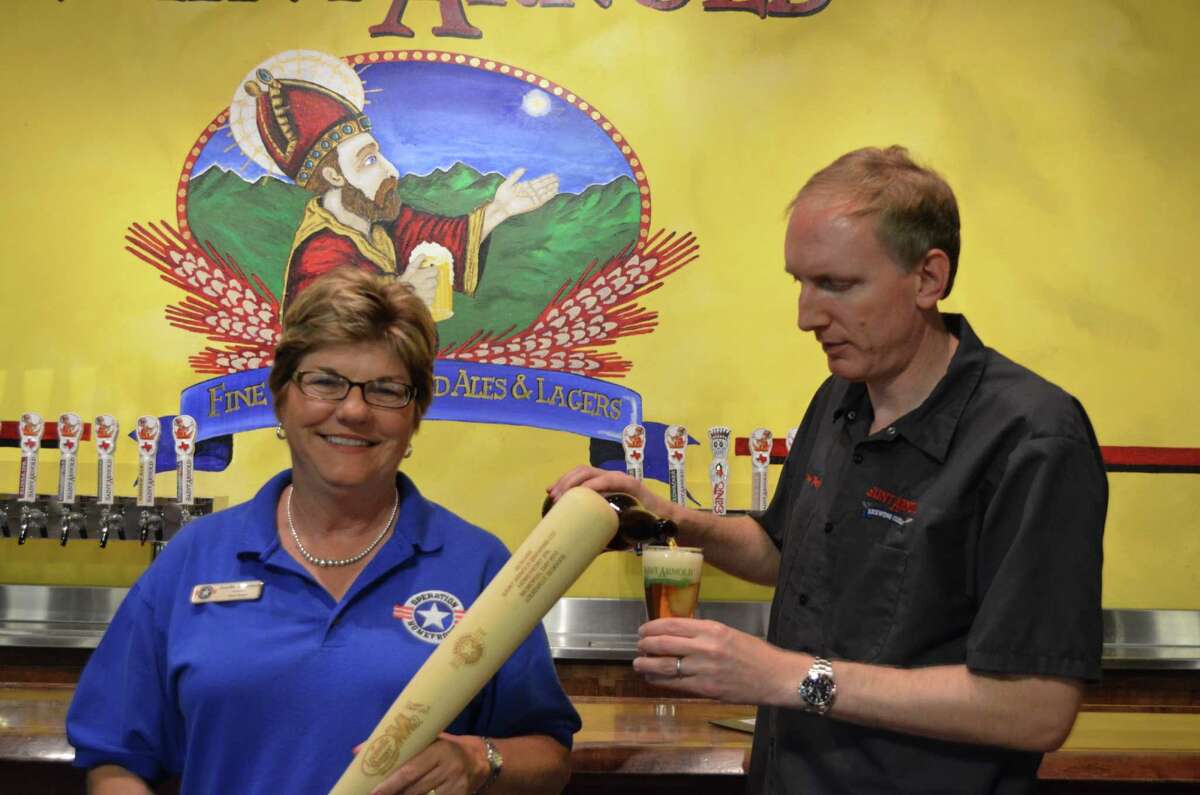 Jennifer Cernoch, left, is president of Operation Homefront of Texas. She is shown with Saint Arnold Brewing Co. founder Brock Wagner. The brewery recently released its Homefront India Pale Ale to support the organization and Texas military families.