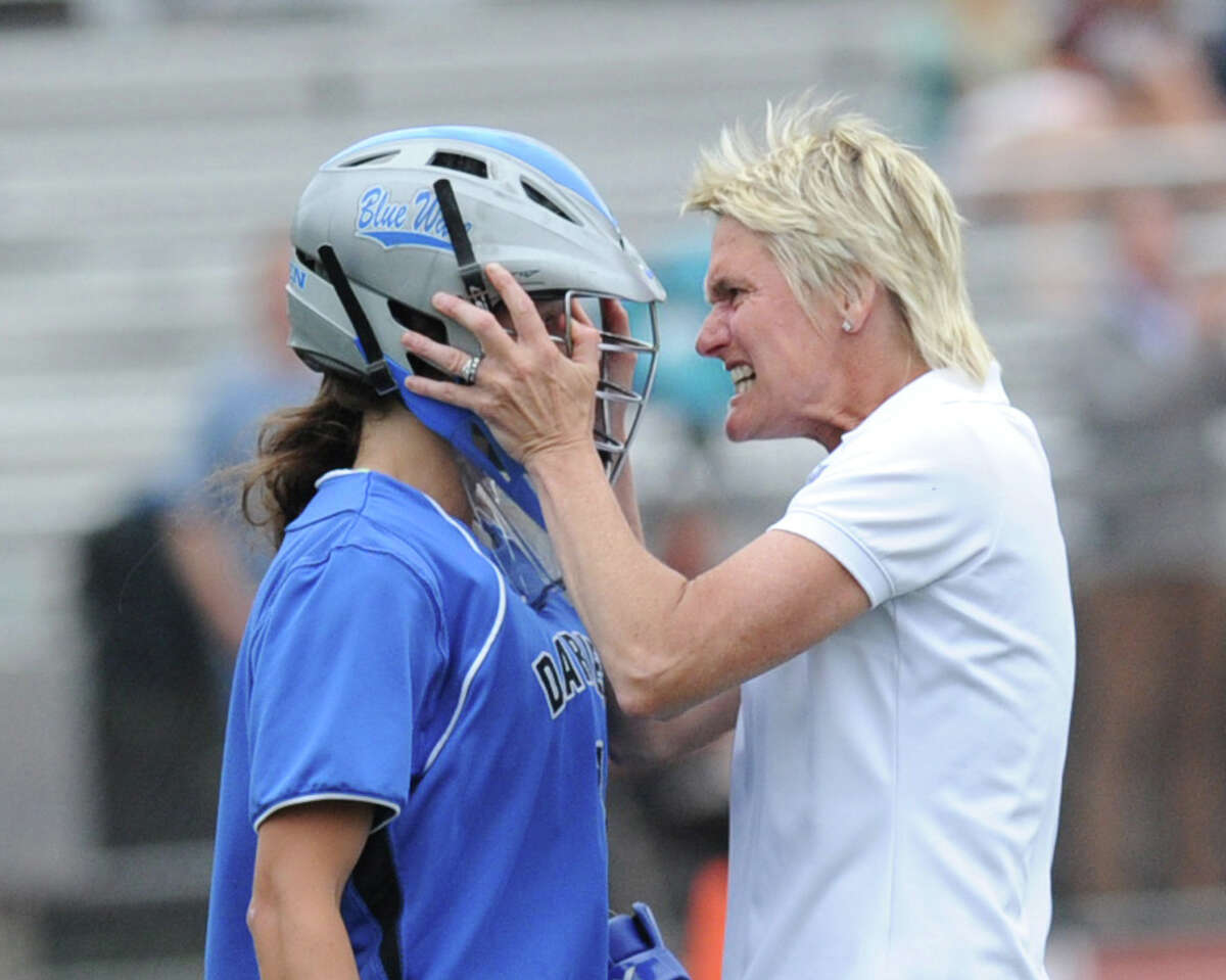 Darien High School girls lacrosse coach Lisa Lindley, right, grabs her goalie Caylee Waters during a timeout in the first half of the FCIAC girls lacrosse finals between Greenwich High School and Darien High School at Brien McMahon High School in Norwalk, Friday, May 25, 2012. Darien won the championship over Greenwich 17-14.