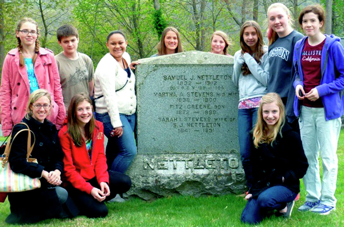 Eighth-grade students at Shepaug Valley Middle School gather recently with social studies teacher Brandi Dougherty, front left, at the gravesite of Samuel Jay Nettleton in Washington. On hand for the photo are, from left to right, front row, Mrs. Dougherty, Molly Thompson and Haley Birdseye, and, back row, Emily Taylor, Lydon Palella, Sadie Fleming, Haley Pesce, Rachel Genua, Emma DelVecchio, Julia Lindblom and Rebecca Swigart. Courtesy of Gunn Memorial Museum