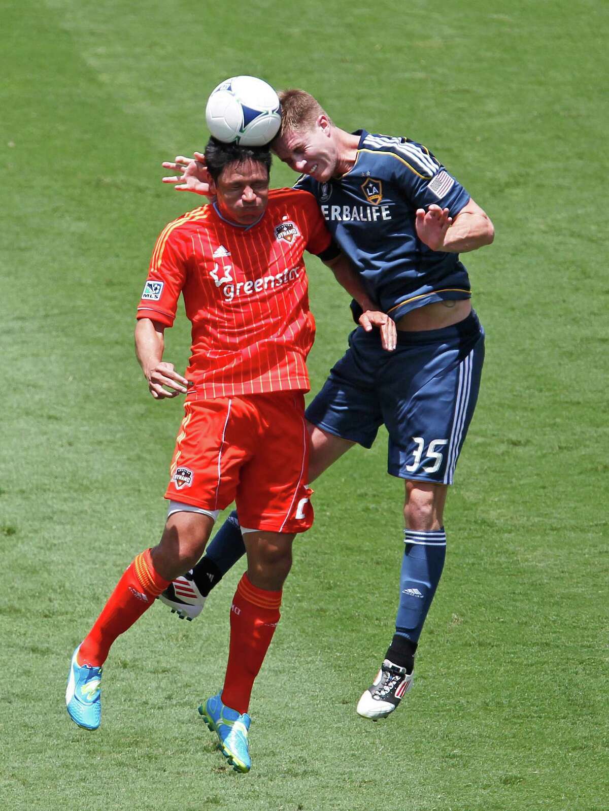 The Houston Dynamo's Brian Ching left and the Los Angeles Galaxy' Bryan Gaul during the first half of MLS game action at BBVA Compass Stadium Saturday, May 26, 2012, in Houston.