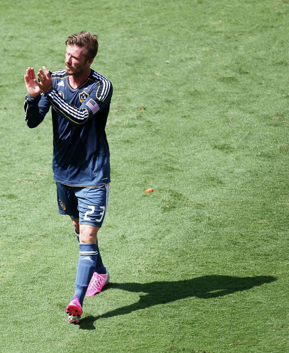 The Los Angeles Galaxy' midfielder David Beckham claps his hands after while leaving the field after the Houston Dynamo defeated the Galaxy 2-1 at BBVA Compass Stadium Saturday, May 26, 2012, in Houston.