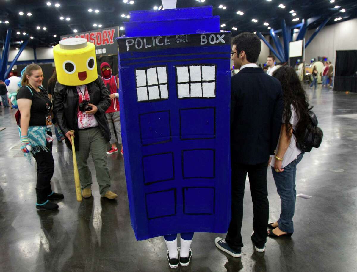Patrons wear different costumes as they attend the Comicpalooza at the George R. Brown Convention Center.