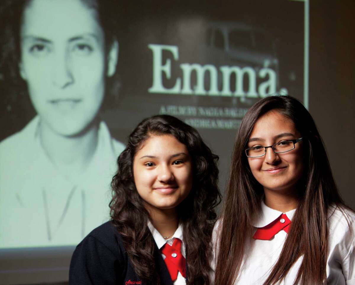 Young Women’s Leadership Academy students Andrea Martinez (left) and Nadia Balderas pose in front of an introduction screen to their documentary about 1930s local labor organizer Emma Tenayuca.