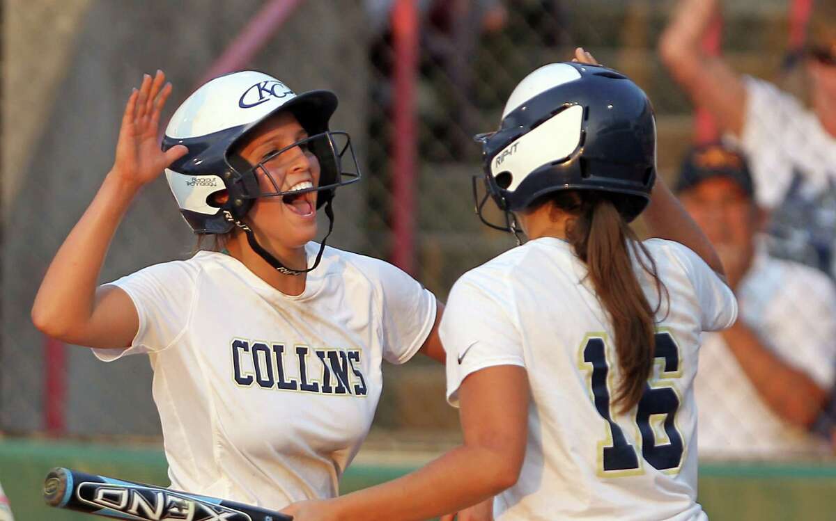Klein Collins High School's Jessica Borrego, left, celebrates a run with Laura Lopez during the first inning of a Regional 2 Final high school softball game against The Woodlands High School, Friday, May 25, 2012, in Houston. ( Nick de la Torre / Houston Chronicle )