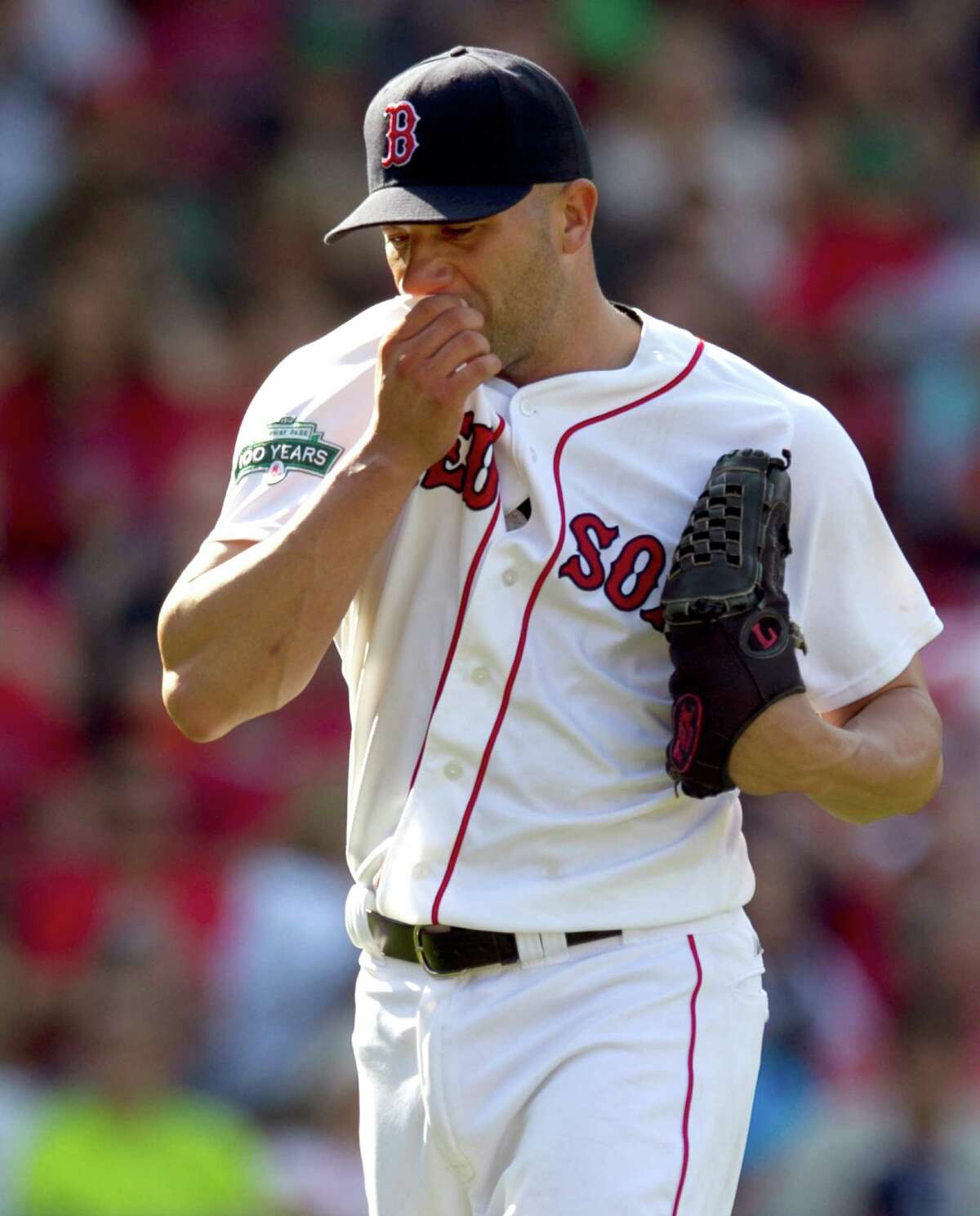 Boston Red Sox pitcher Alfredo Aceves wipes his face on his jersey as he steps off the mound after giving up two runs to the Tampa Bay Rays in the ninth inning of a baseball game at Fenway Park in Boston, Sunday, May 27, 2012. The Rays won 4-3. (AP Photo/Steven Senne)