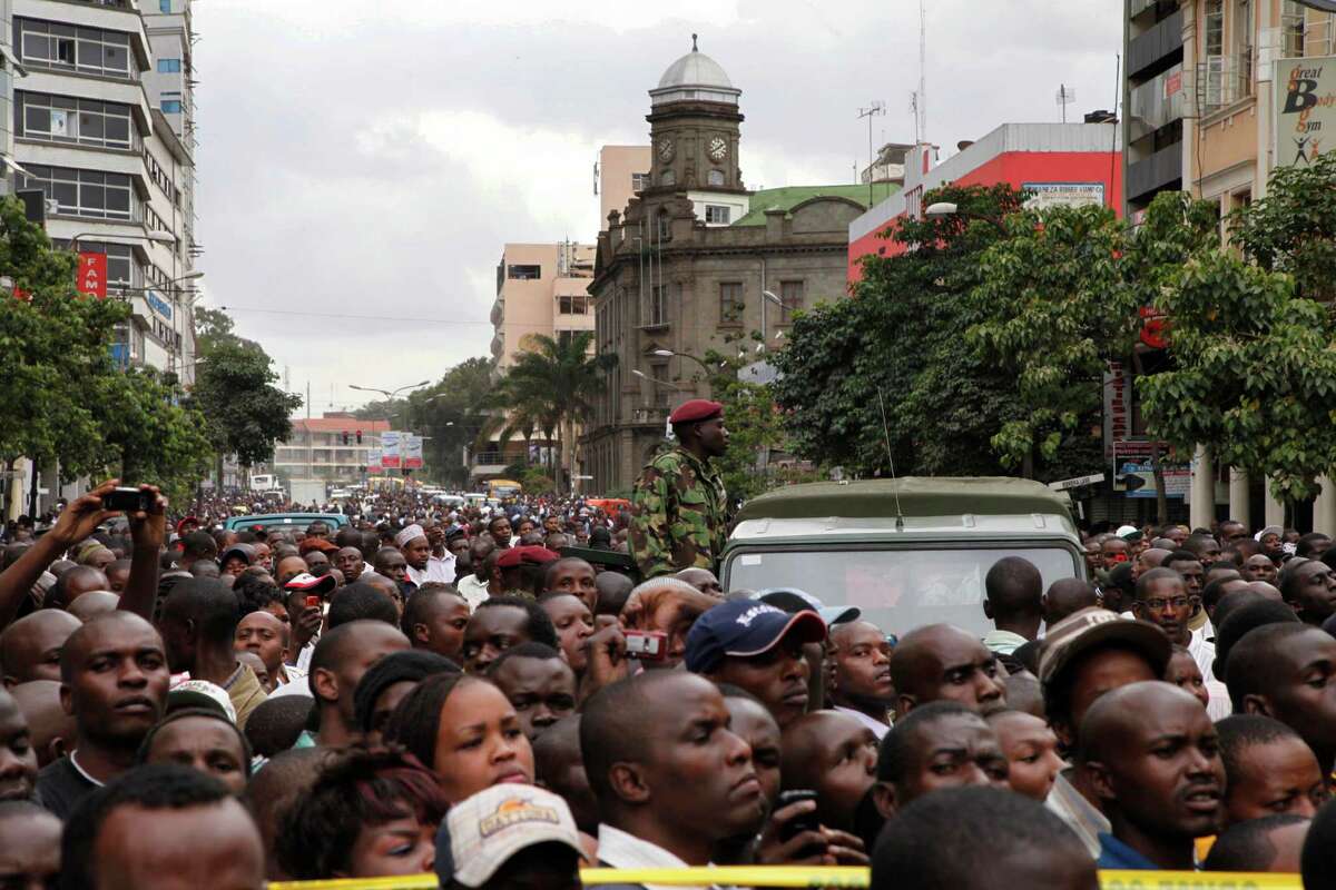 Crowds jam the street after an explosion on a busy road in downtown Nairobi, Kenya, Monday, May 28, 2012. An explosion ripped through a building full of small shops in downtown Nairobi on Monday, wounding at least 16 people, the police commissioner said. He could not immediately say what caused the early morning blast that sent smoke billowing out of the building and over the city. (AP Photo/Sayyid Azim)