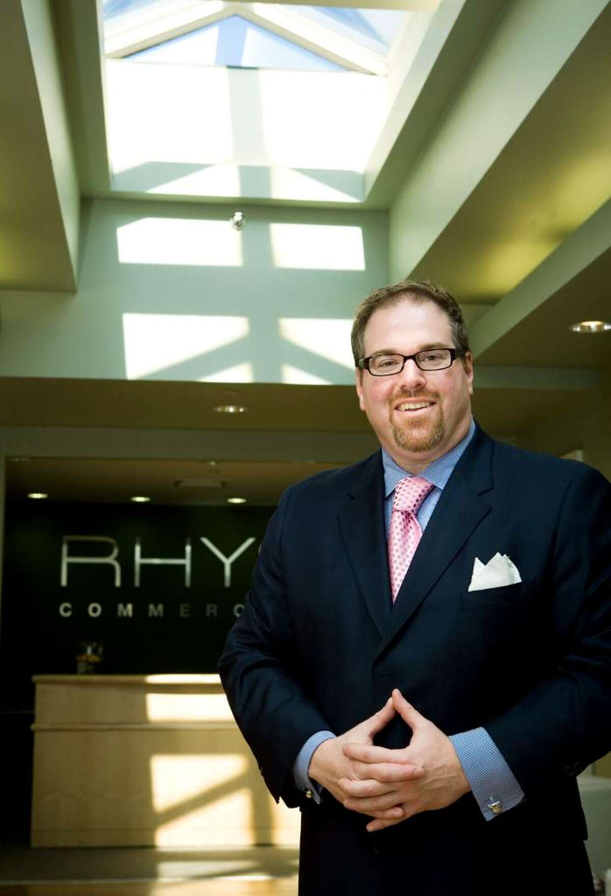 Cory Gubner recently started RHYS, his own commercial real estate firm. He is photographed at their office on West Park Place in Stamford.
