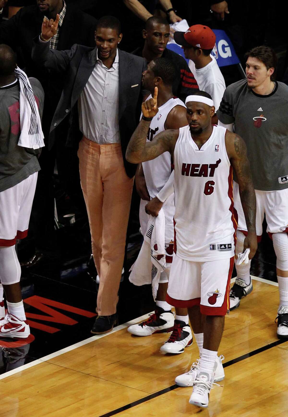 Miami Heat's Chris Bosh, left, Dwyane Wade, center, and LeBron James (6) walk off the court after defeated the Boston Celtics 93-79 during the second half of Game 1 in their NBA basketball Eastern Conference Finals playoff series, Monday, May 28, 2012, in Miami. (AP Photo/Wilfredo Lee)