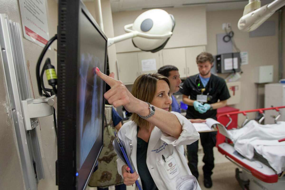 Dr. Rosemary Kozar points to a patients X-ray in a trauma room at Memorial Hermann Hospital on Saturday, May 26, 2012, in Houston.