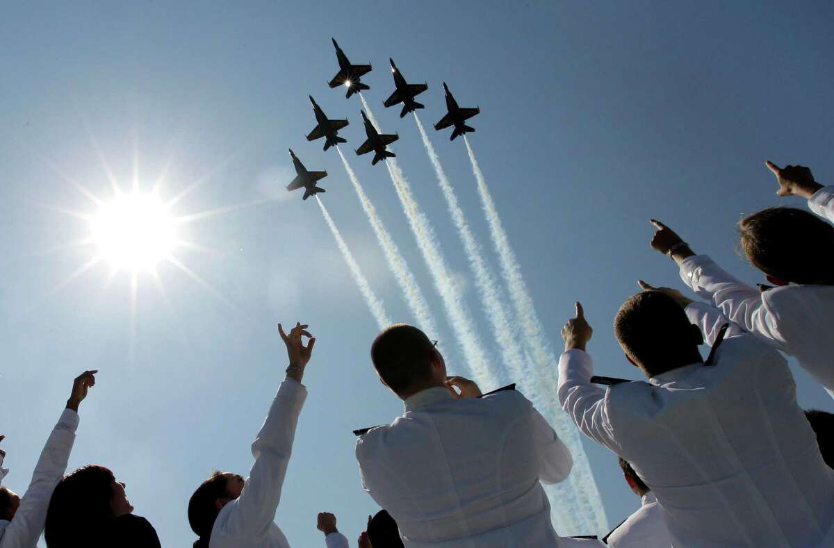 A formation of U.S. Navy Blue Angel fighter jets perform a flyover above graduating Midshipmen during the United States Naval Academy graduation and commissioning ceremonies in Annapolis, Md., Tuesday, May 29, 2012. (AP Photo/Patrick Semansky)