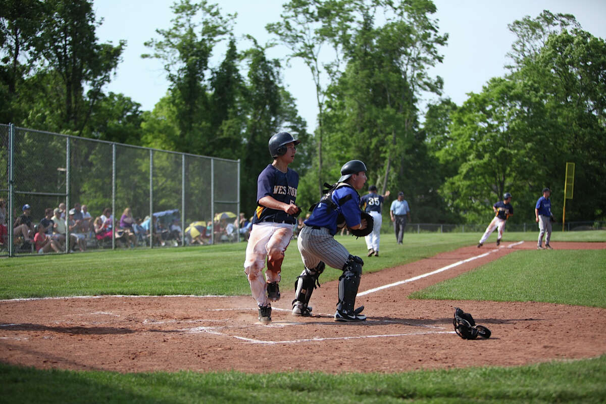 Weston's Ethan Lee-Tyson crosses home plate Tuesday in a 6-3 Class M playoff win over Suffield.