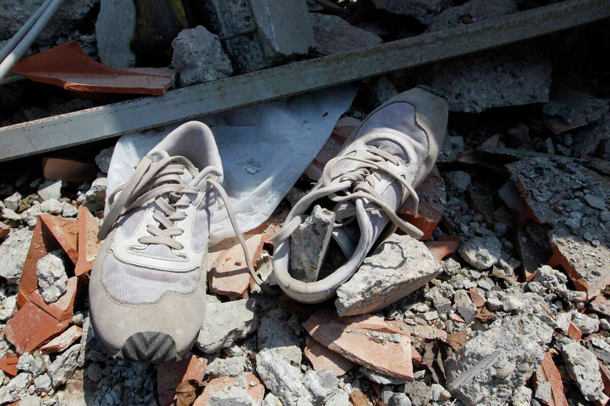 A pair of shoes is seen amid debris of the collapsed BBG industrial moldings building in Mirandola, northern Italy, Wednesday. A magnitude 5.8 earthquake struck the same area of northern Italy stricken by another fatal tremor on May 20.