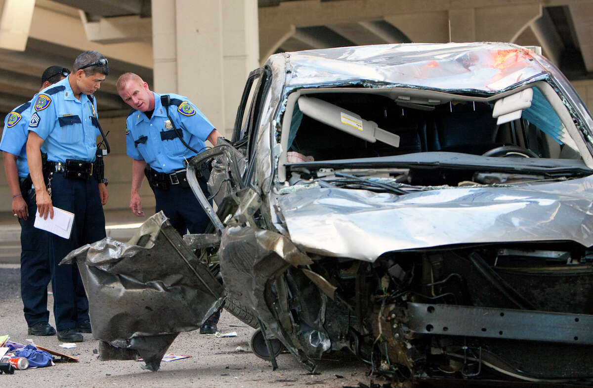 Police investigate an accident after a woman jumped the barrier of a slip ramp from Katy Freeway onto the 290 HOV lane Wednesday, May 30, 2012, in Houston. The driver was traveling at a high rate of speed when she jumped the barrier and hit the TxDot Field Office under the overpass. She was taken to Memorial Hermann Memorial and was conscious and breathing.
