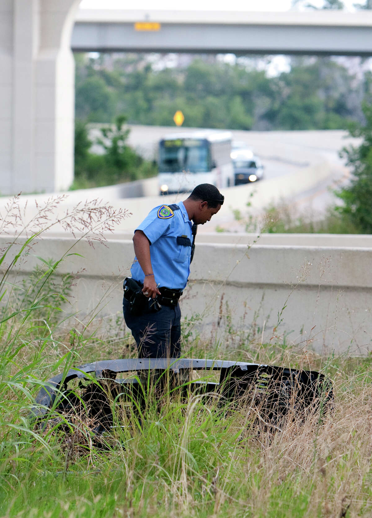 Police investigate an accident after a woman jumped the barrier of a slip ramp from Katy Freeway onto the 290 HOV lane Wednesday, May 30, 2012, in Houston. The driver was traveling at a high rate of speed when she jumped the barrier and hit the TxDot Field Office under the overpass. She was taken to Memorial Hermann Memorial and was conscious and breathing.