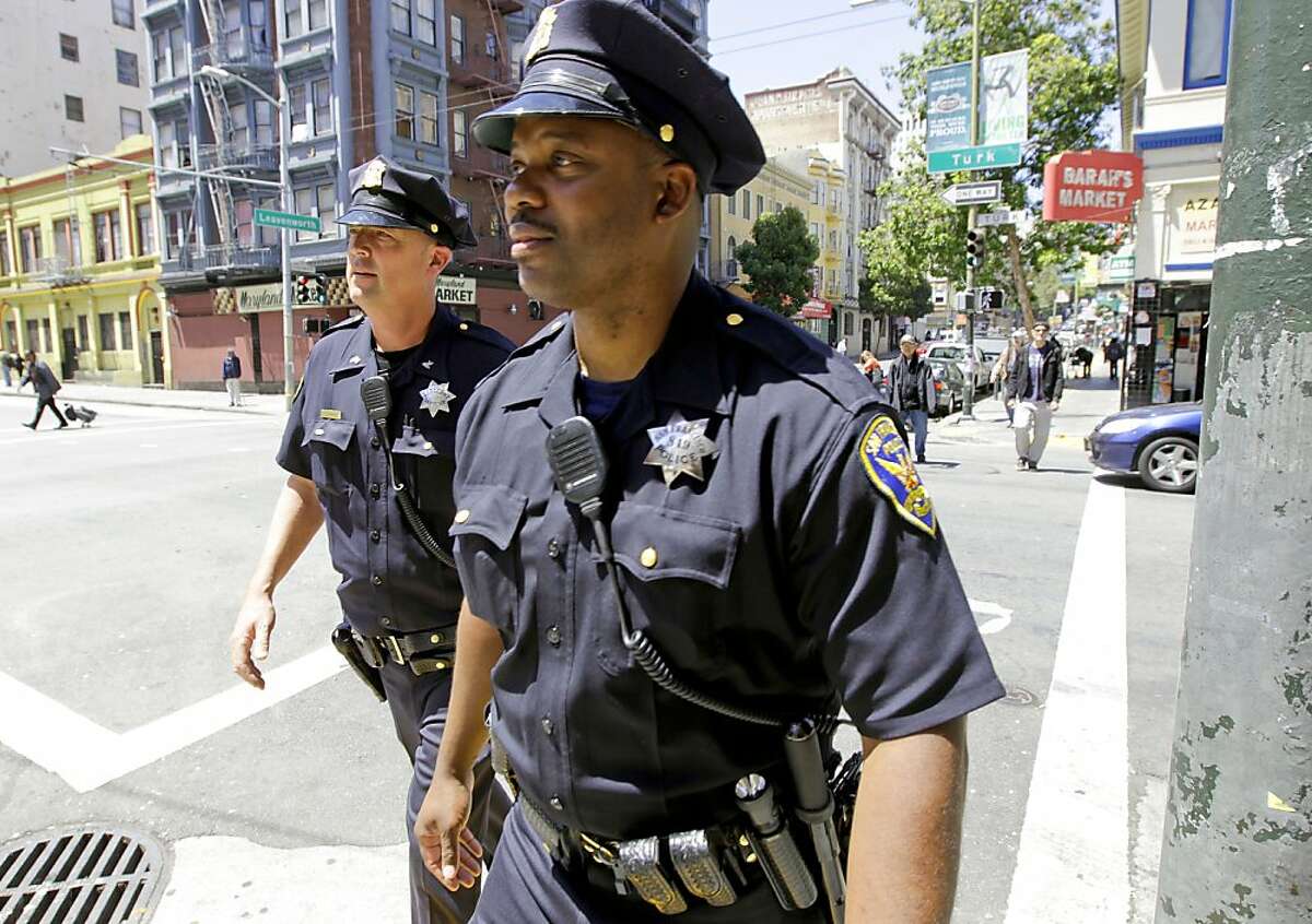 San Francisco police officers, Sgt. Ian Furminger, (l) and Dennis Toomer, work the Tenderloin district along Leavenworth St., on Wednesday May 30, 2012, in San Francisco, Ca. San Francisco Mayor Ed Lee, will announce he has a six year plan to restore police staffing to 1971 levels.