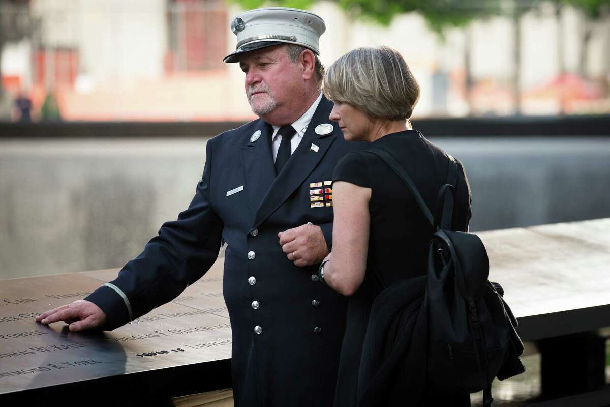 Retired FDNY Lt. Jerry Collins and his wife Suzanne Collins pause at the 9/11 Memorial, Wednesday, May 30, 2012, in New York. Recovery workers and first responders were invited to the memorial to be honored on the 10-year anniversary of the conclusion of clean-up efforts that stretched nine months until May 30, 2002.