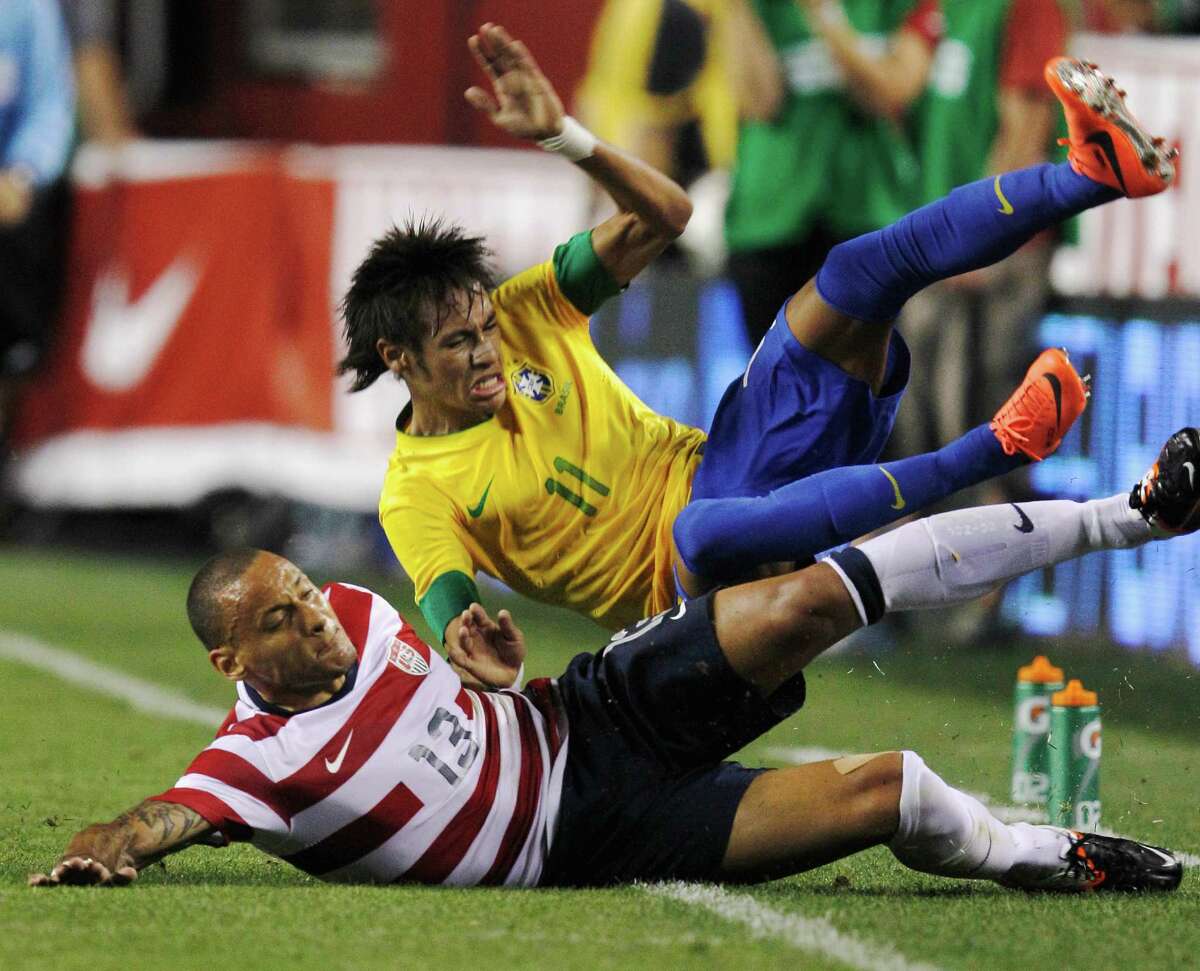 LANDOVER, MD - MAY 30: Neymar #11 of Brazil and Jermaine Jones #13 of USA collide going after the ball during an International friendly game at FedExField on May 30, 2012 in Landover, Maryland.