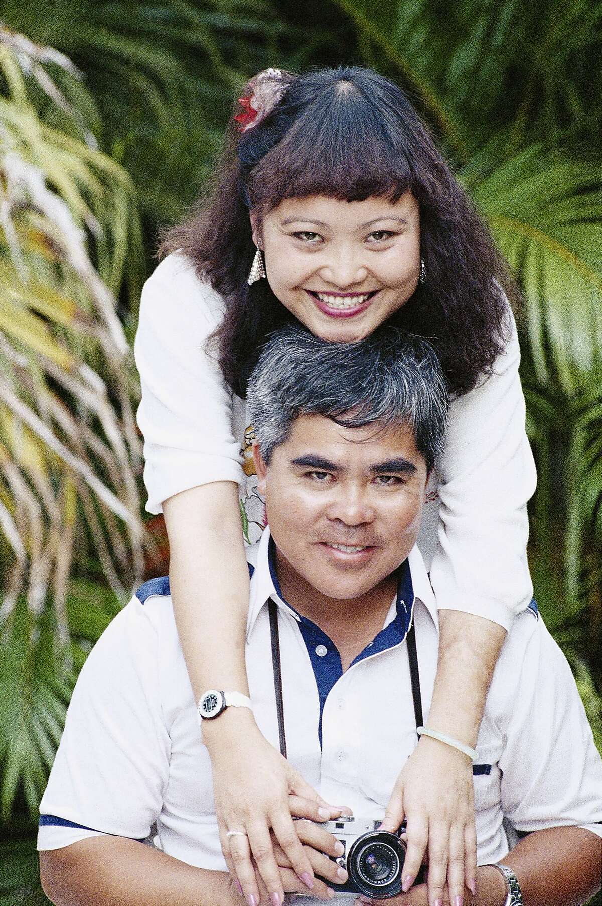 FILE - In this Aug. 17, 1989 file photo, Phan Thi Kim Phuc embraces Associated Press staff photographer Nick Ut during a reunion in Havana, Cuba. It only took a second for Ut to snap the iconic black-and-white image of her after a napalm attack in 1972. It communicated the horrors of the Vietnam War in a way words could never describe, helping to end one of America's darkest eras. But beneath the photo lies a lesser-known story. It's the tale of a dying child brought together by chance with a young photographer. A moment captured in the chaos of war that would serve as both her savior and her curse on a journey to understand life's plan for her. (AP Photo/Jim Caccavo)