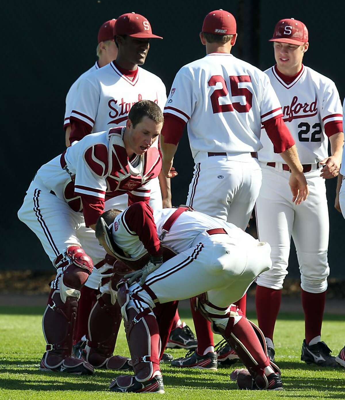 Stanford starting catcher Eric Smith left warms up with teammates prior to the first pitch against the University of California at Stanford?•s Sunken Diamond Friday, May 25, 2012 in Stanford Calif.