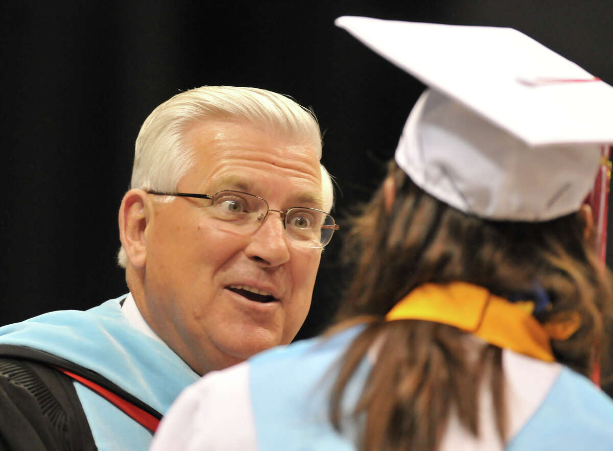 Superintendent John Folks hands out diploma's during one of his last high school graduations Thursday evening in the Alamodome for Taft High School and Communications Arts High School.
