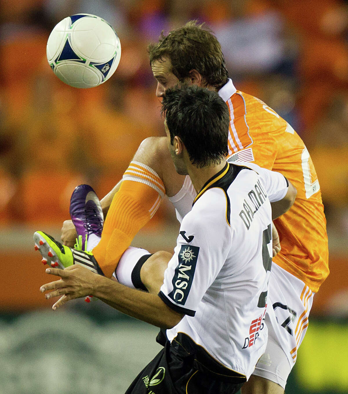 Houston Dynamo midfielder Brian Ownby (22) gets tangled with Valencia midfielder Alert Dalmau (5) during second half of the BBVA Compass Dynamo Charities Cup friendly soccer match on Thursday, May 31, 2012, at BBVA Compass Stadium in Houston. Valencia won the game 2-1.