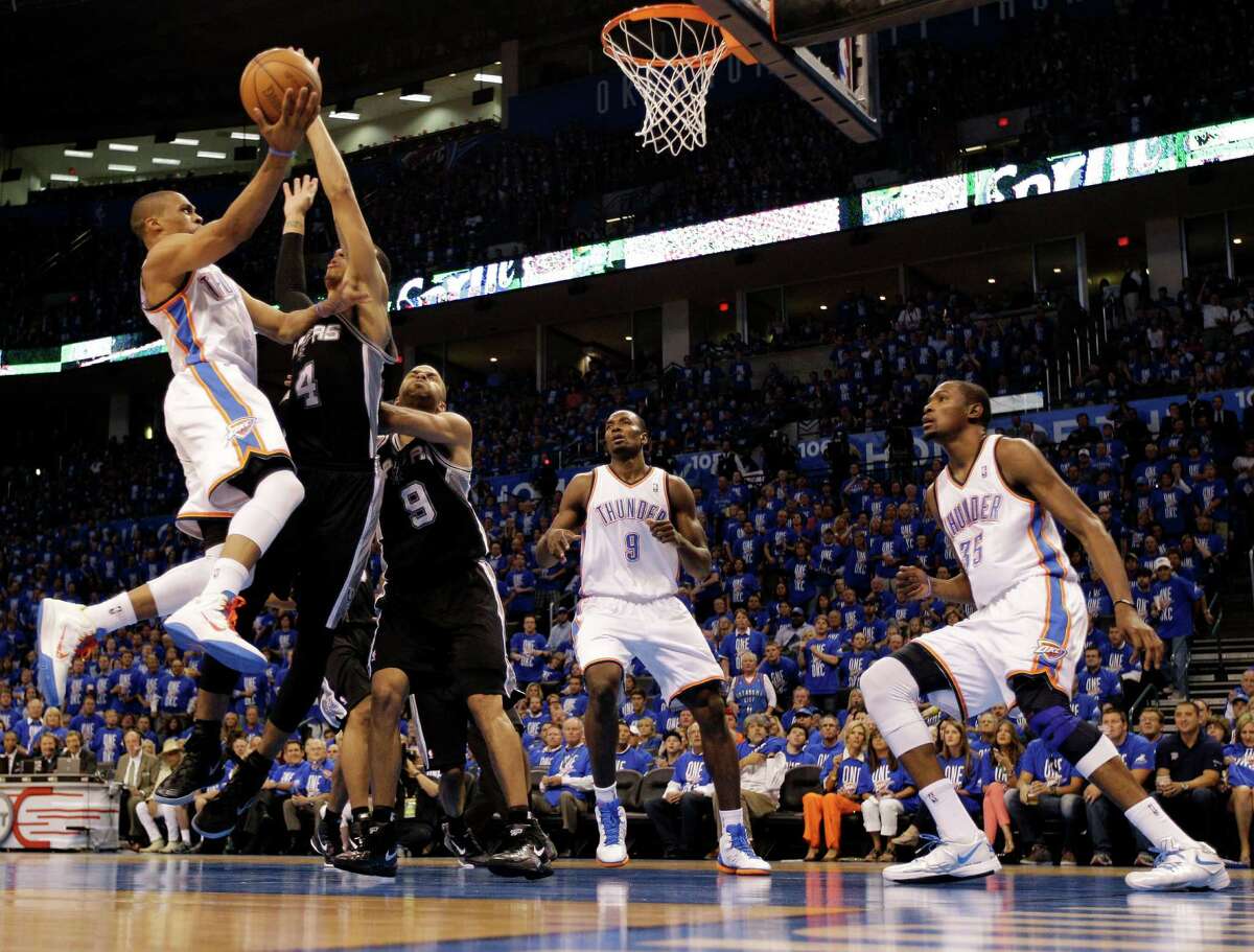 Oklahoma City Thunder point guard Russell Westbrook, left, shoots against San Antonio Spurs guard Danny Green (4) and guard Tony Parker (9) as Thunder's Serge Ibaka (9) and Kevin Durant (35) watch during the second half of Game 3 in their NBA basketball Western Conference finals playoff series, Thursday, May 31, 2012, in Oklahoma City. The Thunder won the game, but trail the series, 2-1. (AP Photo/Eric Gay)