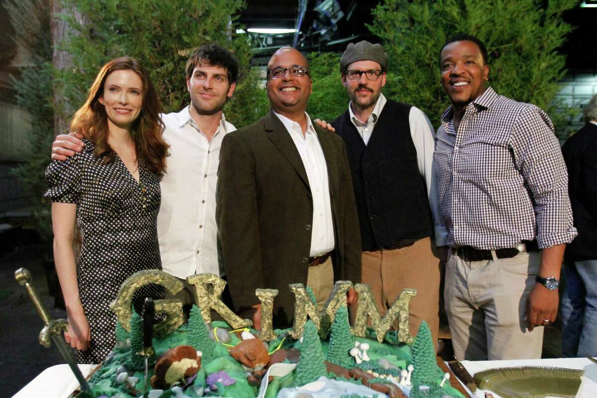 Grimm cast members, from left, Bitsie Tulloch, David Giuntoli, Silas Weir Mitchell and Russell Hornsby pose with NBC executive Bruce Evans, middle, during the kickoff party of second season production for their NBC television series in Portland, Ore., Tuesday, May 29, 2012. Grimm is filmed in Portland.(AP Photo/Don Ryan)