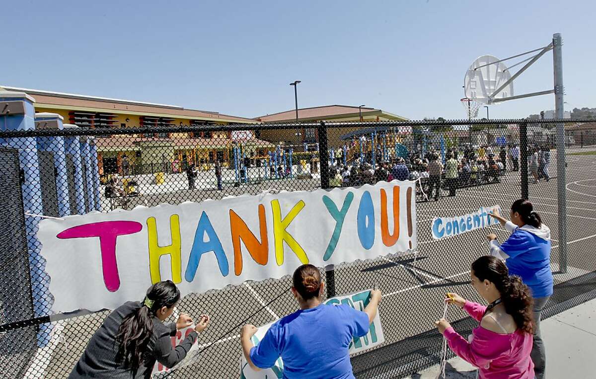 Parents and volunteers decorate the school grounds for the ceremony at the newly rebuilt Ford Elementary School in Richmond, Ca. on Friday June 1, 2012. After 20 years, the West Contra Costa Unified School District will pay off it's debt to the State of California.
